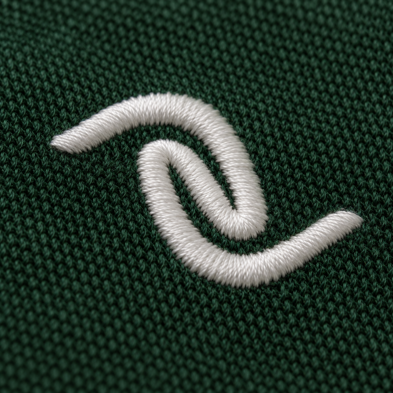 Close-up embroidery texture on green fabric